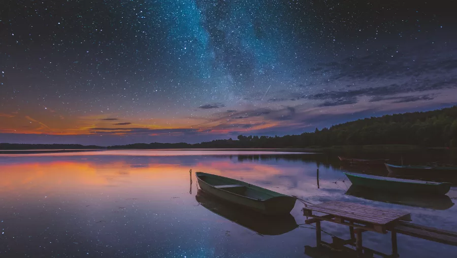 A lake, a boat, a sunset and the stars. Velorum Wealth Management can help build financial legacies that shine for generations.